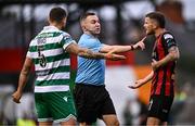 23 June 2025; Referee Kevin O'Sullivan with Lee Grace of Shamrock Rovers and Adam McDonnell of Bohemians during the SSE Airtricity Men's Premier Division match between Bohemians and Shamrock Rovers at Dalymount Park in Dublin. Photo by Ramsey Cardy/Sportsfile