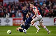 23 June 2025; Michael Duffy of Derry City is tackled by Sean Hoare of St Patrick's Athletic during the SSE Airtricity Men's Premier Division match between St Patrick's Athletic and Derry City at Richmond Park in Dublin. Photo by Ben McShane/Sportsfile