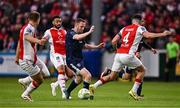 23 June 2025; Shane Ferguson of Derry City in action against St Patrick's Athletic players, from left, Jamie Lennon, Jake Mulraney and Joe Redmond during the SSE Airtricity Men's Premier Division match between St Patrick's Athletic and Derry City at Richmond Park in Dublin. Photo by Ben McShane/Sportsfile