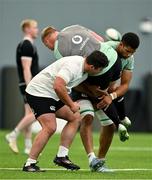 24 June 2025; Ciaran Frawley is tackled by Thomas Clarkson, left, and Cormac Izuchukwu during the Ireland rugby squad training at the IRFU High Performance Centre at the Sport Ireland Campus in Dublin. Photo by Brendan Moran/Sportsfile