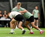 24 June 2025; Ben Murphy is tackled by Thomas Clarkson during the Ireland rugby squad training at the IRFU High Performance Centre at the Sport Ireland Campus in Dublin. Photo by Brendan Moran/Sportsfile