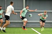 24 June 2025; Ben Murphy passes to Sam Prendergast during the Ireland rugby squad training at the IRFU High Performance Centre at the Sport Ireland Campus in Dublin. Photo by Brendan Moran/Sportsfile