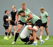 24 June 2025; Cormac Izuchukwu is tackled by Thomas Clarkson during the Ireland rugby squad training at the IRFU High Performance Centre at the Sport Ireland Campus in Dublin. Photo by Brendan Moran/Sportsfile