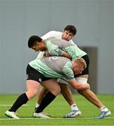 24 June 2025; Cormac Izuchukwu is tackled by Thomas Clarkson and Paddy McCarthy during the Ireland rugby squad training at the IRFU High Performance Centre at the Sport Ireland Campus in Dublin. Photo by Brendan Moran/Sportsfile