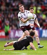 22 June 2025; Cein Darcy of Galway gets a pass away from Miceal Rooney of Down during the GAA Football All-Ireland Senior Championship preliminary quarter-final match between Down and Galway at Páirc Esler in Newry, Down. Photo by Ben McShane/Sportsfile