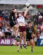 22 June 2025; Matthew Tierney of Galway and Daniel Guinness of Down contest a high-ball during the GAA Football All-Ireland Senior Championship preliminary quarter-final match between Down and Galway at Páirc Esler in Newry, Down. Photo by Ben McShane/Sportsfile