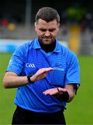 22 June 2025; Referee Conor Dourneen performs the coin toss before the Electric Ireland GAA Football All-Ireland Minor Championship semi-final match between Kerry and Mayo at Zimmer Biomet Páirc Chíosóg in Ennis, Clare. Photo by Brendan Moran/Sportsfile
