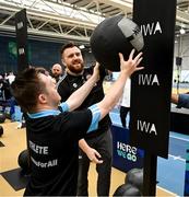 27 June 2025; Sarto Kiernan competes on the wall balls watched by pro heavyweight boxer Thomas Carty during the Fitness Inclusion Games by IWA at the Sport Ireland Indoor Arena on the National Sports Campus in Dublin. Photo by David Fitzgerald/Sportsfile
