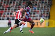 27 June 2025; Aaron Harper-Bailey of Drogheda United in action against Gavin Whyte of Derry City during the SSE Airtricity Men's Premier Division match between Derry City and Drogheda United at The Ryan McBride Brandywell Stadium in Derry. Photo by Shauna Clinton/Sportsfile