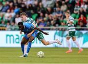 27 June 2025; James Olayinka of Waterford is tackled by Matt Healy of Shamrock Rovers during the SSE Airtricity Men's Premier Division match between Shamrock Rovers and Waterford at Tallaght Stadium in Dublin. Photo by Thomas Flinkow/Sportsfile