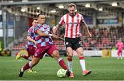 27 June 2025; Kevin Holt of Derry City in action against Douglas James-Taylor of Drogheda United during the SSE Airtricity Men's Premier Division match between Derry City and Drogheda United at The Ryan McBride Brandywell Stadium in Derry. Photo by Shauna Clinton/Sportsfile