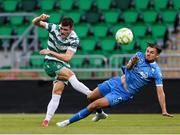 27 June 2025; Josh Honohan of Shamrock Rovers attempts a shot on goal despite the efforts of Grant Horton of Waterford during the SSE Airtricity Men's Premier Division match between Shamrock Rovers and Waterford at Tallaght Stadium in Dublin. Photo by Thomas Flinkow/Sportsfile