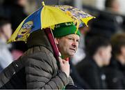 27 June 2025; A supporter shelters from the rain during the SSE Airtricity Men's Premier Division match between Cork City and St Patrick's Athletic at Turner's Cross in Cork. Photo by Brendan Moran/Sportsfile