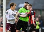 27 June 2025; Referee Declan Toland separated Oskar van Hattum of Sligo Rovers and Ross Tierney of Bohemians during the SSE Airtricity Men's Premier Division match between Bohemians and Sligo Rovers at Dalymount Park in Dublin. Photo by Seb Daly/Sportsfile