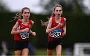 28 June 2025; Twin sisters Lucy Shore of Portlaoise AC, Laois, left, and Ava Shore of Portlaoise AC, Laois compete in the Girls Under 17 3000m during day one of the 123.ie National Juveniles Track & Field Championships at Tullamore Harriers Athletics Club in Offaly. Photo by Ben McShane/Sportsfile