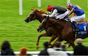 28 June 2025; Suzie Songs, left, with Colin Keane up, on their way to winning the Jebel Ali Racecourse Anglesey Stakes, from second place Flushing Meadows, right, with Ryan Moore up, during day two of the Dubai Duty Free Irish Derby Festival at The Curragh Racecourse in Kildare. Photo by Seb Daly/Sportsfile