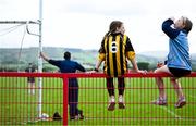 28 June 2025; Naomh Mearnóg supporters sit pitchside during the Football Division 1 match between Ballytubber and Naomh Mearnóg at the John West Féile Peile na nÓg Gaelic Football and LGFA National Finals at Derry GAA Centre of Excellence in Owenbeg, Derry. Photo by Shauna Clinton/Sportsfile