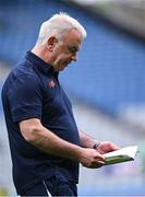 28 June 2025; Monaghan manager Gabriel Bannigan reads the match programme as he walks the pitch before the GAA Football All-Ireland Senior Championship quarter-final match between Monaghan and Donegal at Croke Park in Dublin. Photo by Piaras Ó Mídheach/Sportsfile