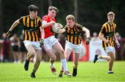 28 June 2025; Cillian Donnelly of Ballytubber in action against Cian Leavy, left, and Aaron Mulryan of Naomh Mearnóg during the Football Division 1 match between Ballytubber and Naomh Mearnóg at the John West Féile Peile na nÓg Gaelic Football and LGFA National Finals at Derry GAA Centre of Excellence in Owenbeg, Derry. Photo by Shauna Clinton/Sportsfile