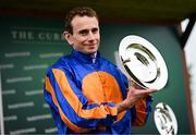 28 June 2025; Jockey Ryan Moore with the trophy after riding Whirl to victory in the Paddy Power Pretty Polly Stakes during day two of the Dubai Duty Free Irish Derby Festival at The Curragh Racecourse in Kildare. Photo by Seb Daly/Sportsfile