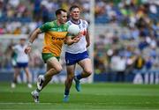 28 June 2025; Caolan McColgan of Donegal in action against Andrew Woods of Monaghan during the GAA Football All-Ireland Senior Championship quarter-final match between Monaghan and Donegal at Croke Park in Dublin. Photo by Ray McManus/Sportsfile