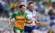 28 June 2025; Caolan McColgan of Donegal in action against Andrew Woods of Monaghan during the GAA Football All-Ireland Senior Championship quarter-final match between Monaghan and Donegal at Croke Park in Dublin. Photo by Ray McManus/Sportsfile