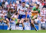 28 June 2025; Conor O'Donnell of Donegal scores a point under pressure from Conor McCarthy, left, Gary Mohan of Monaghan during the GAA Football All-Ireland Senior Championship quarter-final match between Monaghan and Donegal at Croke Park in Dublin. Photo by Piaras Ó Mídheach/Sportsfile