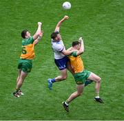 28 June 2025; Andrew Woods of Monaghan in action against Eoghan Bán Gallagher, left, and Jason McGee of Donegal during the GAA Football All-Ireland Senior Championship quarter-final match between Monaghan and Donegal at Croke Park in Dublin. Photo by Daire Brennan/Sportsfile