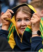 28 June 2025; A Donegal supporter shelters from the rain during the GAA Football All-Ireland Senior Championship quarter-final match between Monaghan and Donegal at Croke Park in Dublin. Photo by David Fitzgerald/Sportsfile