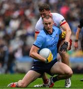 28 June 2025; Peadar Ó Cofaigh Byrne of Dublin is tackled by Brian Kennedy of Tyrone during the GAA Football All-Ireland Senior Championship quarter-final match between Dublin and Tyrone at Croke Park in Dublin. Photo by Ray McManus/Sportsfile