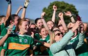 28 June 2025; Claregalway supporter Anne Fahy takes a selfie with players after their side's victory in the LGFA Division 1 final match between Claregalway and Ballinderry Shamrocks at the John West Féile Peile na nÓg Gaelic Football and LGFA National Finals at Derry GAA Centre of Excellence in Owenbeg, Derry. Photo by Shauna Clinton/Sportsfile