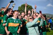 28 June 2025; Claregalway supporter Anne Fahy takes a selfie with players after their side's victory in the LGFA Division 1 final match between Claregalway and Ballinderry Shamrocks at the John West Féile Peile na nÓg Gaelic Football and LGFA National Finals at Derry GAA Centre of Excellence in Owenbeg, Derry. Photo by Shauna Clinton/Sportsfile