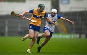 28 June 2025; Gavin Marshall of Clare in action against Bradley Penkert of Waterford during the Electric Ireland GAA Hurling All-Ireland Minor Championship final match between Waterford and Clare at FBD Semple Stadium in Thurles, Tipperary. Photo by Brendan Moran/Sportsfile