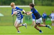 28 June 2025; Oisin Lynch of Naas in action against Dean Samspon of New York during the Football Division 1 Cup Final match between Naas and New York at the John West Féile Peile na nÓg Gaelic Football and LGFA National Finals at Derry GAA Centre of Excellence in Owenbeg, Derry. Photo by Shauna Clinton/Sportsfile