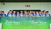 28 June 2025; Naas captains Oisin Lynch, left, and Matthew McCarthy with team-mates and the cup after their side's victory in the Football Division 1 Cup Final match between Naas and New York at the John West Féile Peile na nÓg Gaelic Football and LGFA National Finals at Derry GAA Centre of Excellence in Owenbeg, Derry. Photo by Shauna Clinton/Sportsfile