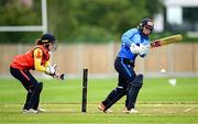 29 June 2025; Typhoons batter Leah Paul plays a shot, watched by Scorchers wicketkeeper Christina Coulter Reilly, during the Evoke Super 20 Trophy match between Typhoons and Scorchers at Railway Union Cricket Club in Dublin. Photo by Seb Daly/Sportsfile