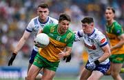 28 June 2025; Conor O'Donnell of Donegal in action against Dylan Byrne, right, and Mícheal McCarville of Monaghan during the GAA Football All-Ireland Senior Championship quarter-final match between Monaghan and Donegal at Croke Park in Dublin. Photo by Ray McManus/Sportsfile