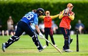29 June 2025; Scorchers wicketkeeper Christina Coulter Reilly runs-out Typhoons batter Jane Maguire during the Evoke Super 20 Trophy match between Typhoons and Scorchers at Railway Union Cricket Club in Dublin. Photo by Seb Daly/Sportsfile