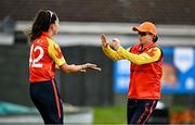 29 June 2025; Scorchers fielder Ciara Gibson, right, celebrates with teammate Ava Canning after taking the wicket of Typhoons batter Rebecca Stokell during the Evoke Super 20 Trophy match between Typhoons and Scorchers at Railway Union Cricket Club in Dublin. Photo by Seb Daly/Sportsfile