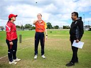 29 June 2025; Scorchers captain Christina Coulter Reilly, centre, with Dragons captain Amy Hunter, left, and match referee Bala Kailash during the toss before the Evoke Super 20 Trophy match between Scorchers and Dragons at Railway Union Cricket Club in Dublin. Photo by Seb Daly/Sportsfile
