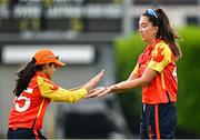 29 June 2025; Scorchers players Sibha Bhoja, left, Ava Canning celebate a wicket during the Evoke Super 20 Trophy match between Typhoons and Scorchers at Railway Union Cricket Club in Dublin. Photo by Seb Daly/Sportsfile