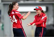 29 June 2025; Dragons bowler Orla Prendergast, left, celebrates with teammate Cara Murray after taking the wicket of Scorchers batter Eimear Richardson during the Evoke Super 20 Trophy match between Scorchers and Dragons at Railway Union Cricket Club in Dublin. Photo by Seb Daly/Sportsfile