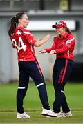 29 June 2025; Dragons bowler Orla Prendergast, left, celebrates with teammate Cara Murray after taking the wicket of Scorchers batter Eimear Richardson during the Evoke Super 20 Trophy match between Scorchers and Dragons at Railway Union Cricket Club in Dublin. Photo by Seb Daly/Sportsfile