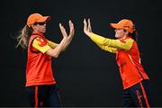29 June 2025; Scorchers fielder Eimear Richardson, left, celebrates with teammate Lara McBride after taking the wicket of Dragons batter Bella Armstrong during the Evoke Super 20 Trophy match between Scorchers and Dragons at Railway Union Cricket Club in Dublin. Photo by Seb Daly/Sportsfile