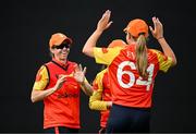 29 June 2025; Scorchers fielder Eimear Richardson, left, celebrates with teammate Louise Little after taking the wicket of Dragons batter Bella Armstrong during the Evoke Super 20 Trophy match between Scorchers and Dragons at Railway Union Cricket Club in Dublin. Photo by Seb Daly/Sportsfile