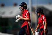 29 June 2025; Dragons batters Orla Prendergast, left, and Amy Hunter after the Evoke Super 20 Trophy match between Scorchers and Dragons at Railway Union Cricket Club in Dublin. Photo by Seb Daly/Sportsfile