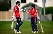29 June 2025; Dragons batters Orla Prendergast, left, and Amy Hunter after the Evoke Super 20 Trophy match between Scorchers and Dragons at Railway Union Cricket Club in Dublin. Photo by Seb Daly/Sportsfile