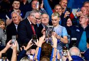 28 June 2025; Waterford captain James Comerford is presented with the Irish Press Cup by Uachtarán Chumann Lúthchleas Gael Jarlath Burns after the Electric Ireland GAA Hurling All-Ireland Minor Championship final match between Waterford and Clare at FBD Semple Stadium in Thurles, Tipperary. Photo by Brendan Moran/Sportsfile