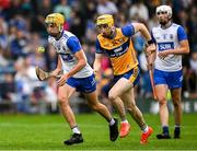 28 June 2025; Hugo Quann of Waterford in action against Jake Gibbons of Clare during the Electric Ireland GAA Hurling All-Ireland Minor Championship final match between Waterford and Clare at FBD Semple Stadium in Thurles, Tipperary. Photo by Brendan Moran/Sportsfile