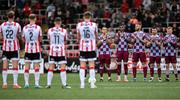 27 June 2025; Players from both teams observe a minute's silence in honour of the late Mary Higgins, mother of former Derry City manager Ruaidhri Higgins, before the SSE Airtricity Men's Premier Division match between Derry City and Drogheda United at The Ryan McBride Brandywell Stadium in Derry. Photo by Shauna Clinton/Sportsfile